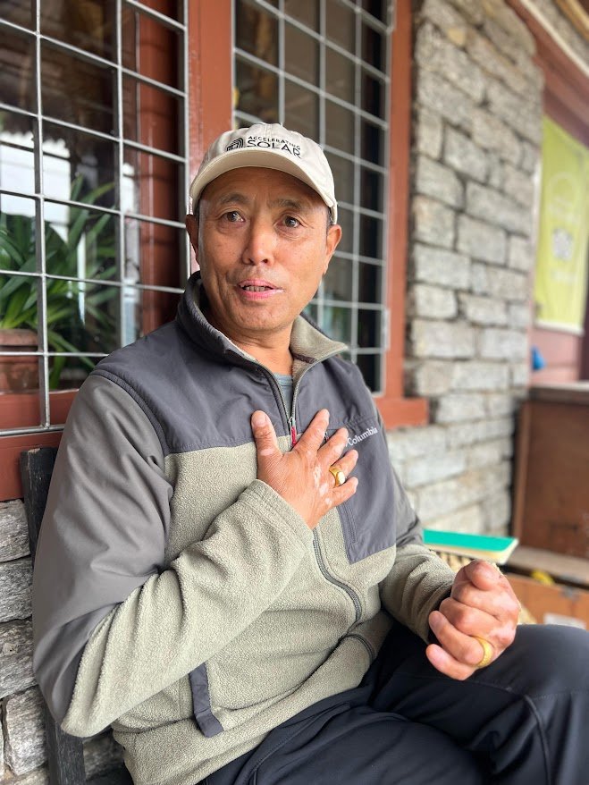 Portrait of Kisam Gurung, founder and owner of Gurung Cottage Nepal, known for his hospitality and scenic Annapurna mountain retreat.